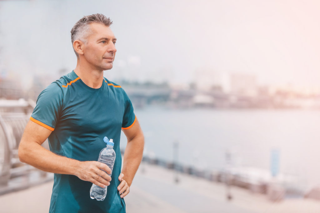 man drinking water after exercise